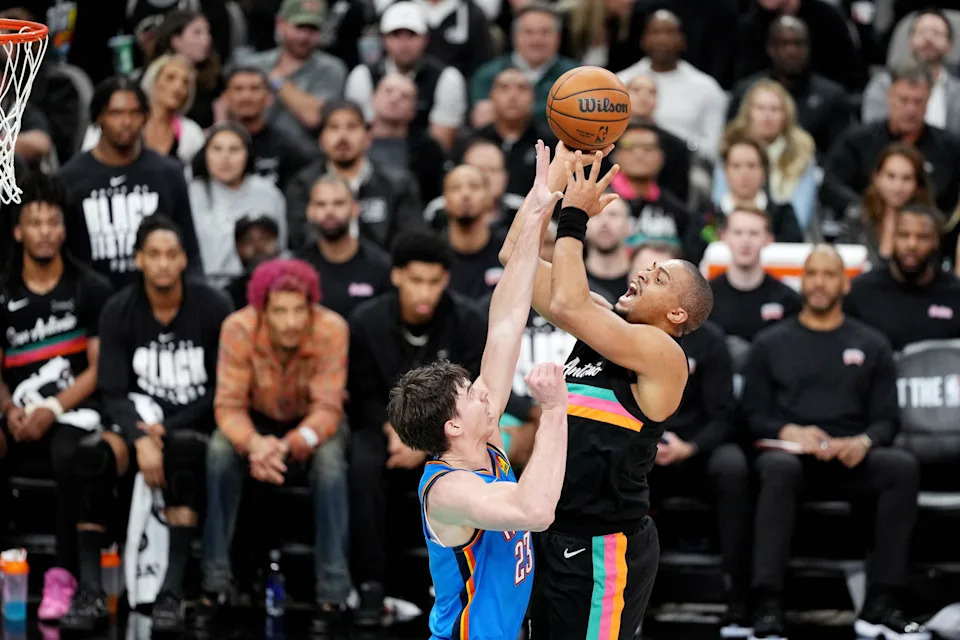 Feb 4, 2026; San Antonio, Texas, USA; San Antonio Spurs forward Keldon Johnson (3) shoots over Oklahoma City Thunder guard Brooks Barnhizer (23) during the first half at Frost Bank Center. Mandatory Credit: Scott Wachter-Imagn Images