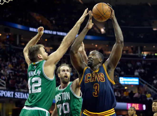 Mar 3, 2015; Cleveland, OH, USA; Cleveland Cavaliers center Kendrick Perkins (3) shoots against Boston Celtics forward Shavlik Randolph (42) and forward Luigi Datome (70) in the fourth quarter at Quicken Loans Arena. Mandatory Credit: David Richard-USA TODAY Sports