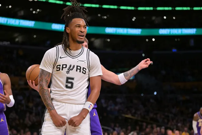 Dec 10, 2025; Los Angeles, California, USA; San Antonio Spurs guard Stephon Castle (5) reacts after a basket and a foul called on Los Angeles Lakers guard Luka Doncic (77) during the first half at Crypto.com Arena. Mandatory Credit: Jayne Kamin-Oncea-Imagn Images
