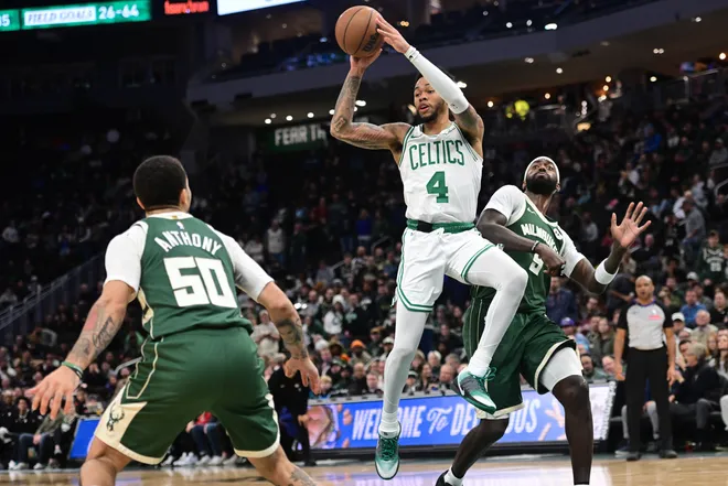 Dec 11, 2025; Milwaukee, Wisconsin, USA; Boston Celtics guard Anfernee Simons (4) looks to pass the ball against Milwaukee Bucks forward Bobby Portis (9) and guard Cole Anthony (50) in the fourth quarter at Fiserv Forum. Mandatory Credit: Benny Sieu-Imagn Images