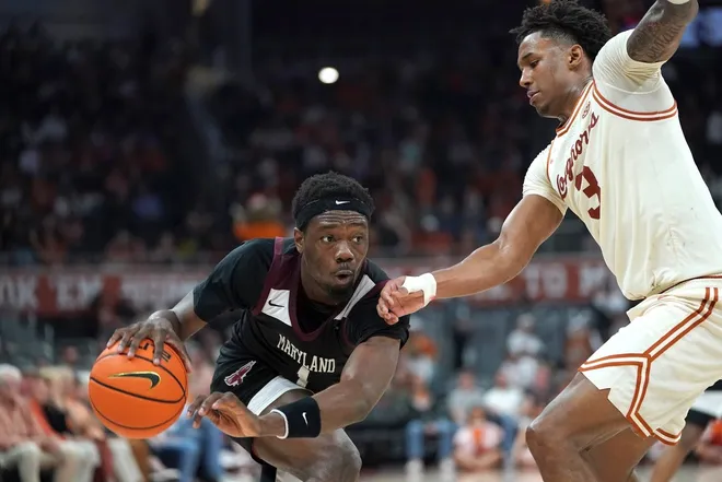 Dec 22, 2025; Austin, Texas, USA;Maryland Eastern Shore Hawks guard Zion Obanla (1) drives the ball against Texas Longhorns guard Dailyn Swain (3) during the second half at Moody Center.