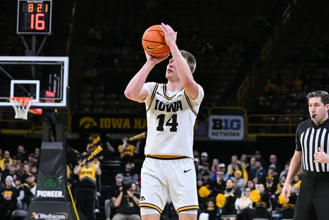 Dec 29, 2025; Iowa City, Iowa, USA; Iowa Hawkeyes guard Bennett Stirtz (14) shoots the ball against the UMass Lowell River Hawks during the second half at Carver-Hawkeye Arena.