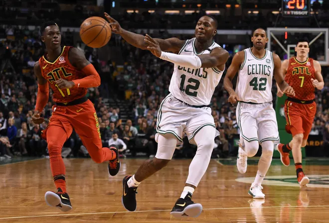 Feb 2, 2018; Boston, MA, USA; Boston Celtics guard Terry Rozier (12) passes the ball while Atlanta Hawks guard Dennis Schroder (17) looks on during the first half at TD Garden. Mandatory Credit: Bob DeChiara-USA TODAY Sports