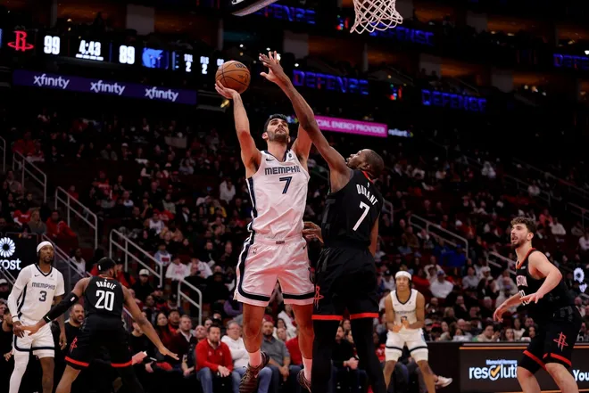 Jan 26, 2026; Houston, Texas, USA; Memphis Grizzlies forward Santi Aldama (7) shoots inside against Houston Rockets forward Kevin Durant (7) during the fourth quarter at Toyota Center.