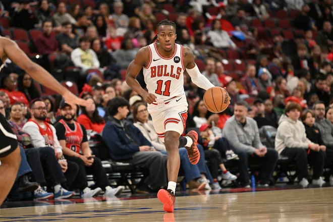 Jan 18, 2026; Chicago, Illinois, USA; Chicago Bulls guard Ayo Dosunmu (11) dribbles against the Brooklyn Nets during the first half at United Center. Mandatory Credit: Patrick Gorski-Imagn Images