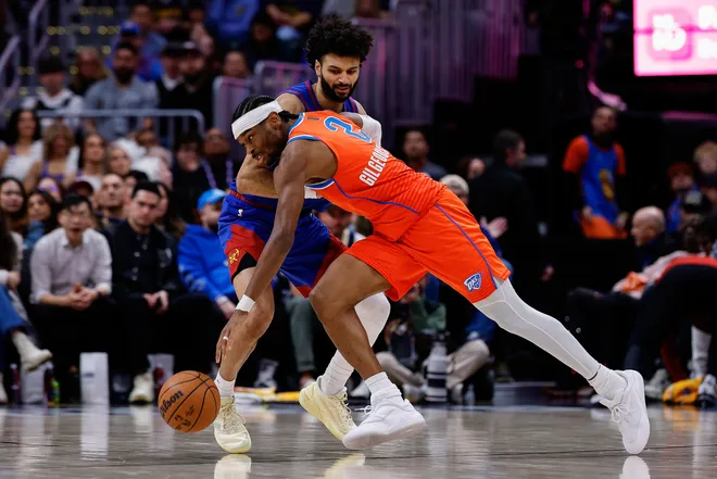 Feb 1, 2026; Denver, Colorado, USA; Oklahoma City Thunder guard Shai Gilgeous-Alexander (2) controls the ball under pressure from Denver Nuggets guard Jamal Murray (27) in the fourth quarter at Ball Arena. Mandatory Credit: Isaiah J. Downing-Imagn Images