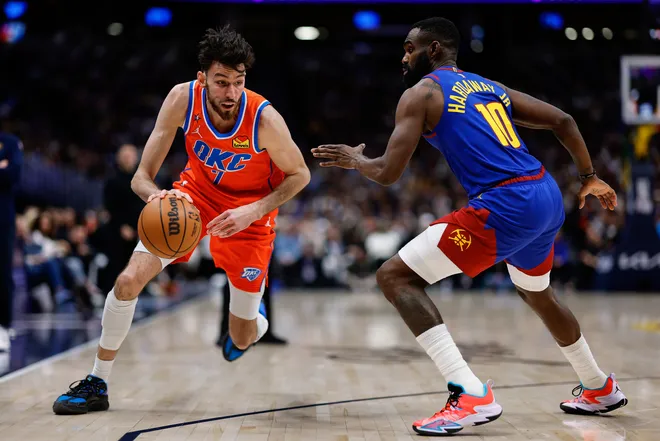 Feb 1, 2026; Denver, Colorado, USA; Oklahoma City Thunder center Chet Holmgren (7) controls the ball as Denver Nuggets guard Tim Hardaway Jr. (10) guards in the second quarter at Ball Arena. Mandatory Credit: Isaiah J. Downing-Imagn Images