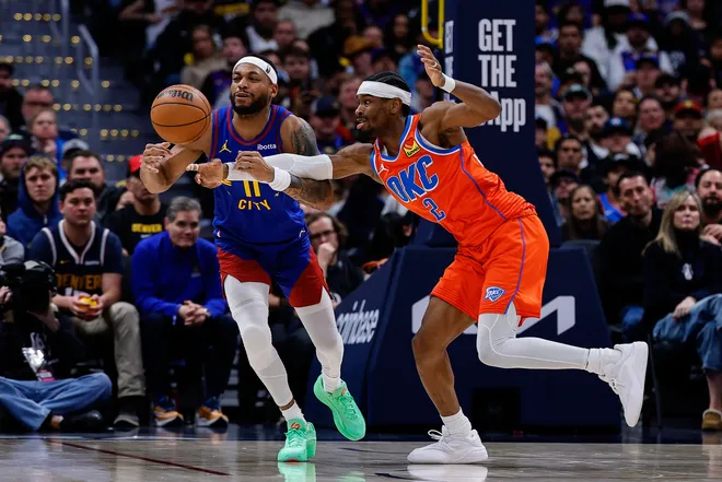 Feb 1, 2026; Denver, Colorado, USA; Denver Nuggets guard Bruce Brown (11) and Oklahoma City Thunder guard Shai Gilgeous-Alexander (2) battle for a loose ball in the fourth quarter at Ball Arena. Mandatory Credit: Isaiah J. Downing-Imagn Images