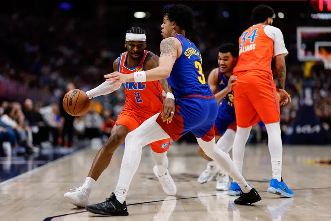 Feb 1, 2026; Denver, Colorado, USA; Oklahoma City Thunder guard Shai Gilgeous-Alexander (2) controls the ball against Denver Nuggets guard Julian Strawther (3) as guard Kenrich Williams (34) defends against forward Spencer Jones (21) in the second quarter at Ball Arena. Mandatory Credit: Isaiah J. Downing-Imagn Images