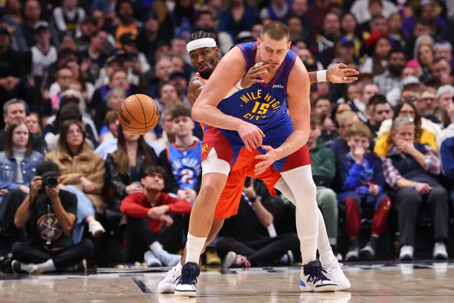 DENVER, COLORADO - FEBRUARY 01: Shai Gilgeous-Alexander #2 of the Oklahoma City Thunder steals the ball from Nikola Jokic #15 of the Denver Nuggets during the fourth quarter at Ball Arena on February 1, 2026 in Denver, Colorado. NOTE TO USER: User expressly acknowledges and agrees that, by downloading and or using this photograph, User is consenting to the terms and conditions of the Getty Images License Agreement. (Photo by Justin Tafoya/Getty Images)