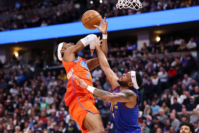 DENVER, COLORADO - FEBRUARY 01: Shai Gilgeous-Alexander #2 of the Oklahoma City Thunder drives to the basket against Bruce Brown #11 of the Denver Nuggets during the fourth quarter at Ball Arena on February 1, 2026 in Denver, Colorado. NOTE TO USER: User expressly acknowledges and agrees that, by downloading and or using this photograph, User is consenting to the terms and conditions of the Getty Images License Agreement. (Photo by Justin Tafoya/Getty Images)