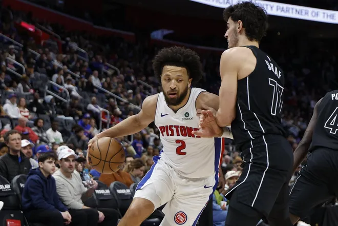 Feb 1, 2026; Detroit, Michigan, USA; Detroit Pistons guard Cade Cunningham (2) dribbles defended by Brooklyn Nets guard Ben Saraf (77) in the second half at Little Caesars Arena.