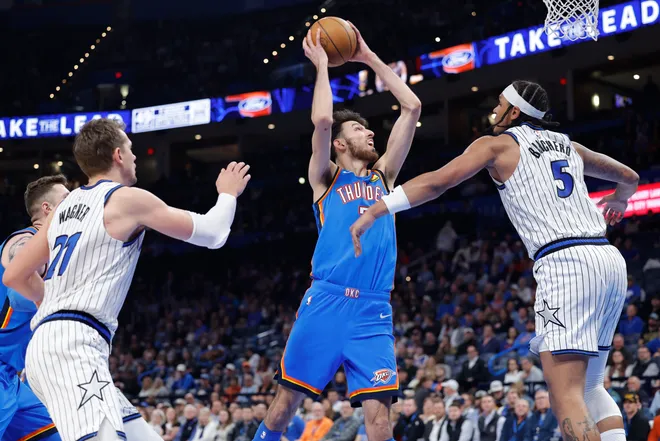 Feb 3, 2026; Oklahoma City, Oklahoma, USA; Oklahoma City Thunder center/forward Chet Holmgren (7) goes up for a basket between Orlando Magic center Orlando Robinson (7) and Oklahoma City Thunder guard Luguentz Dort (5) during the second half at Paycom Center. Mandatory Credit: Alonzo Adams-Imagn Images