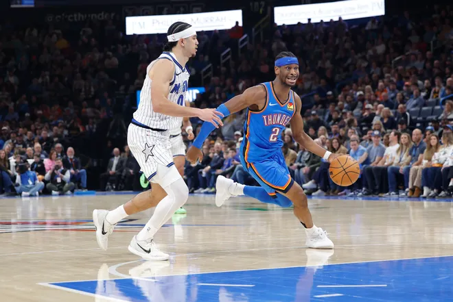 Feb 3, 2026; Oklahoma City, Oklahoma, USA; Oklahoma City Thunder guard Shai Gilgeous-Alexander (2) drives around Orlando Magic forward Jamal Cain (8) during the second half at Paycom Center. Mandatory Credit: Alonzo Adams-Imagn Images