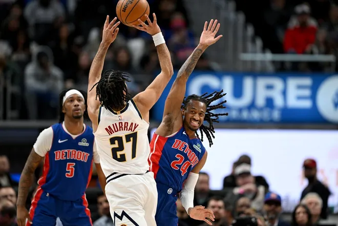 Feb 3, 2026; Detroit, Michigan, USA; Denver Nuggets guard Jamal Murray (27) gets fouled by Detroit Pistons guard Daniss Jenkins (24) as he shoots the ball in the second quarter at Little Caesars Arena.