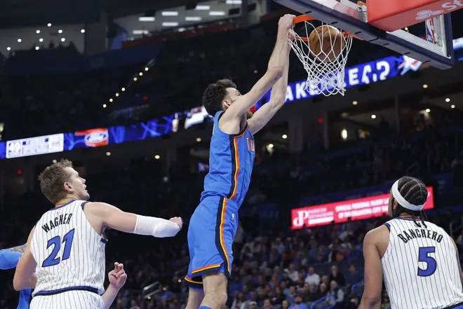 Feb 3, 2026; Oklahoma City, Oklahoma, USA; Oklahoma City Thunder center/forward Chet Holmgren (7) dunks from in between Orlando Magic forward/center Moritz Wagner (21) and forward Paolo Banchero (5) during the second half at Paycom Center.