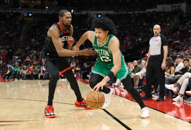 Feb 4, 2026; Houston, Texas, USA; Boston Celtics guard Ron Harper Jr. (13) dribbles the ball as Houston Rockets forward Kevin Durant (7) defends during the third quarter at Toyota Center