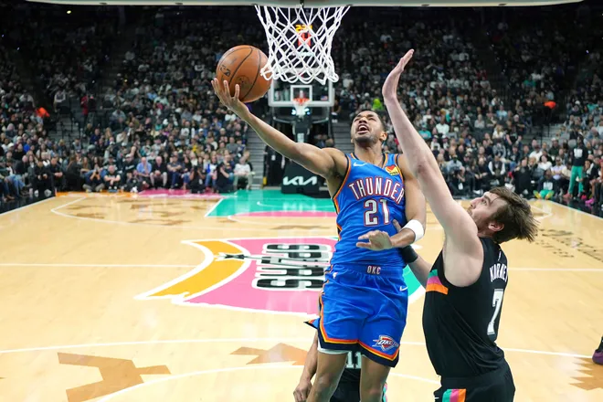 Feb 4, 2026; San Antonio, Texas, USA; Oklahoma City Thunder guard Aaron Wiggins (21) drives to the basket against San Antonio Spurs center Luke Kornet (7) during the first half at Frost Bank Center. Mandatory Credit: Scott Wachter-Imagn Images