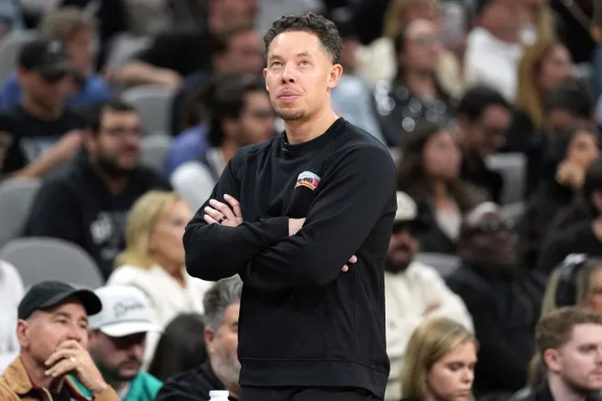 Feb 4, 2026; San Antonio, Texas, USA; San Antonio Spurs Head Coach Mitch Johnson looks at the scoreboard during the second half against the Oklahoma City Thunder at Frost Bank Center. Mandatory Credit: Scott Wachter-Imagn Images
