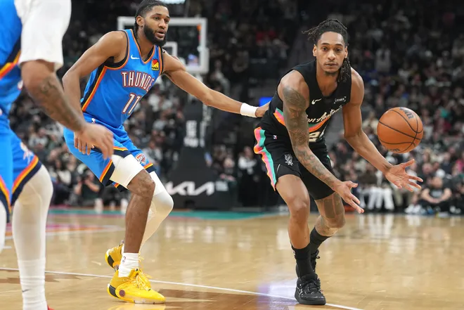 Feb 4, 2026; San Antonio, Texas, USA; San Antonio Spurs guard Devin Vassell (24) passes the ball while defended by guard Isaiah Joe (11) of the Oklahoma City Thunder during the first half at Frost Bank Center. Mandatory Credit: Scott Wachter-Imagn Images