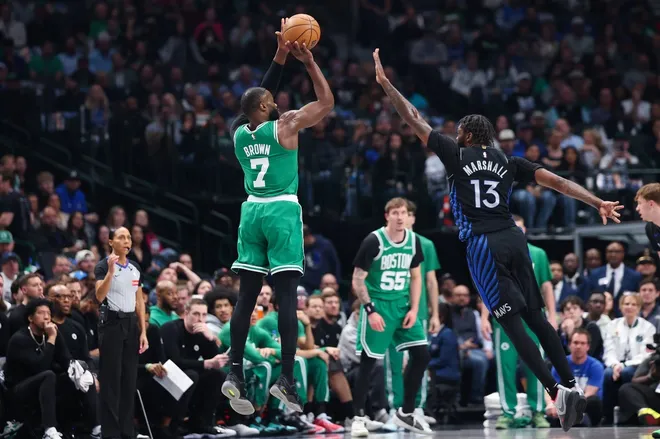 Feb 3, 2026; Dallas, Texas, USA; Boston Celtics guard Jaylen Brown (7) shoots over Dallas Mavericks forward Naji Marshall (13) during the first quarter at American Airlines Center.