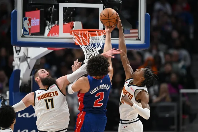 Feb 3, 2026; Detroit, Michigan, USA; Detroit Pistons guard Cade Cunningham (2) has his shot blocked byDenver Nuggets guard Peyton Watson (8) while driving in for a basket in the fourth quarter at Little Caesars Arena.
