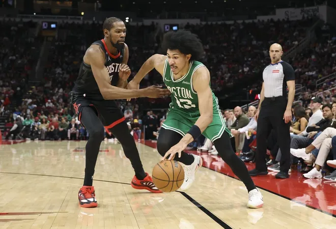 Feb 4, 2026; Houston, Texas, USA; Boston Celtics guard Ron Harper Jr. (13) dribbles the ball as Houston Rockets forward Kevin Durant (7) defends during the third quarter at Toyota Center.