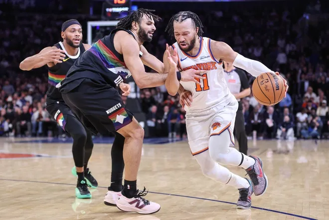 Feb 4, 2026; New York, New York, USA; New York Knicks guard Jalen Brunson (11) looks to drive past Denver Nuggets guard Jamal Murray (27) in the second overtime at Madison Square Garden.