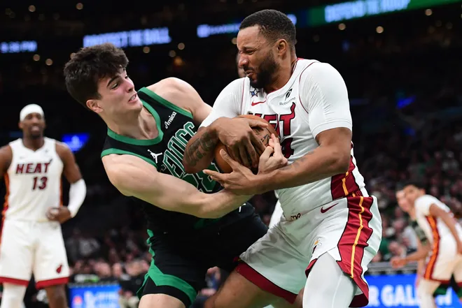 Feb 6, 2026; Boston, Massachusetts, USA; Boston Celtics guard Hugo Gonzalez (28) and Miami Heat guard Norman Powell (24) battle for the ball during the second half at TD Garden. Mandatory Credit: Bob DeChiara-Imagn Images