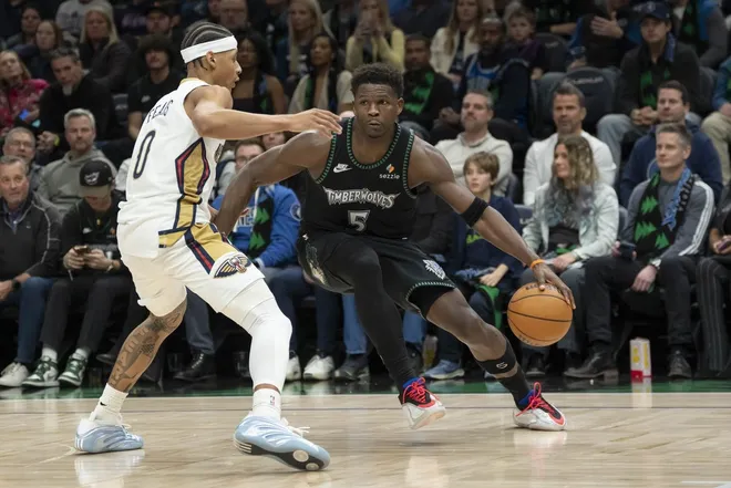 Feb 6, 2026; Minneapolis, Minnesota, USA; Minnesota Timberwolves guard Anthony Edwards (5) dribbles the ball past New Orleans Pelicans guard Jeremiah Fears (0) in the second half at Target Center.