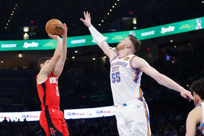 Feb 7, 2026; Oklahoma City, Oklahoma, USA; Houston Rockets guard Reed Sheppard (15) shoots as Oklahoma City Thunder center/forward Isaiah Hartenstein (55) defends during the second half at Paycom Center. Mandatory Credit: Alonzo Adams-Imagn Images