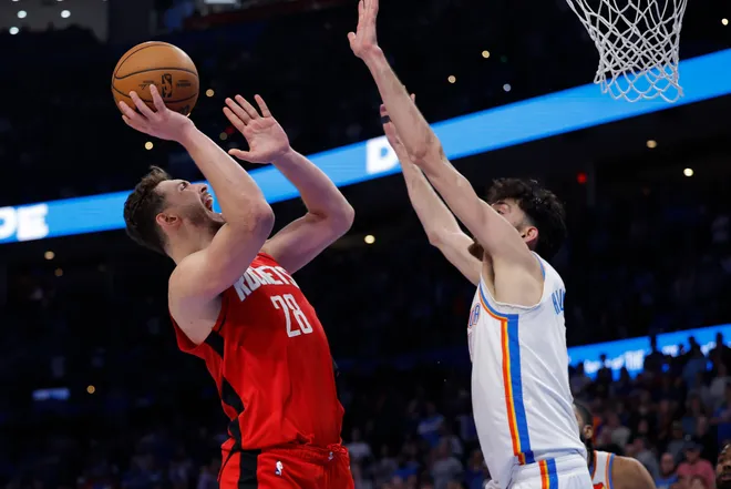 Feb 7, 2026; Oklahoma City, Oklahoma, USA; Houston Rockets center Alperen Sengun (28) shoots as Oklahoma City Thunder center/forward Chet Holmgren (7) defends during the second half at Paycom Center. Mandatory Credit: Alonzo Adams-Imagn Images