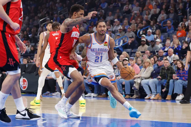 Feb 7, 2026; Oklahoma City, Oklahoma, USA; Oklahoma City Thunder guard Aaron Wiggins (21) drives past Houston Rockets forward Tari Eason (17) during the first half at Paycom Center. Mandatory Credit: Alonzo Adams-Imagn Images