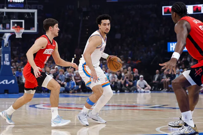 Feb 7, 2026; Oklahoma City, Oklahoma, USA; Oklahoma City Thunder guard Jared McCain (30) moves the ball between Houston Rockets guard Reed Sheppard (15) and center Clint Capela (30) during the first half at Paycom Center. Mandatory Credit: Alonzo Adams-Imagn Images