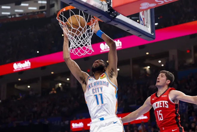Feb 7, 2026; Oklahoma City, Oklahoma, USA; Oklahoma City Thunder guard Isaiah Joe (11) dunks in front of Houston Rockets guard Reed Sheppard (15) during the first half at Paycom Center. Mandatory Credit: Alonzo Adams-Imagn Images