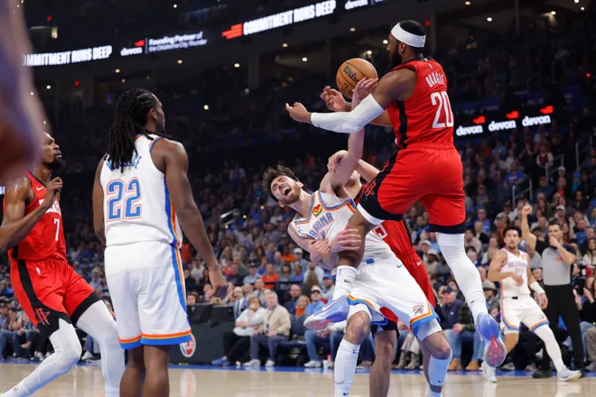 Feb 7, 2026; Oklahoma City, Oklahoma, USA; Oklahoma City Thunder center/forward Chet Holmgren (7) and Houston Rockets guard Josh Okogie (20) reach for a loose ball during the first half at Paycom Center. Mandatory Credit: Alonzo Adams-Imagn Images
