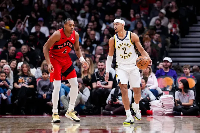 Feb 8, 2026; Toronto, Ontario, CAN; Indiana Pacers guard Andrew Nembhard (2) dribbles against Toronto Raptors forward Scottie Barnes (4) during the first half at Scotiabank Arena. Mandatory Credit: Kevin Sousa-Imagn Images