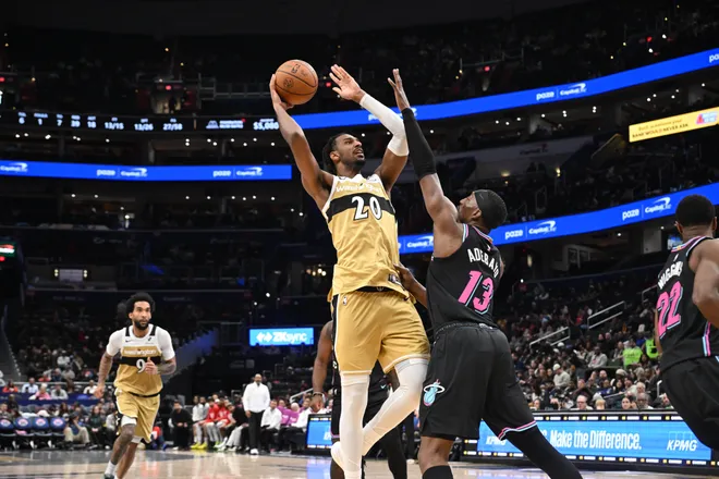 Feb 8, 2026; Washington, District of Columbia, USA; Washington Wizards center Alex Sarr (20) attempts a shot over Miami Heat center Bam Adebayo (13) during the third quarter at Capital One Arena. Mandatory Credit: Rafael Suanes-Imagn Images