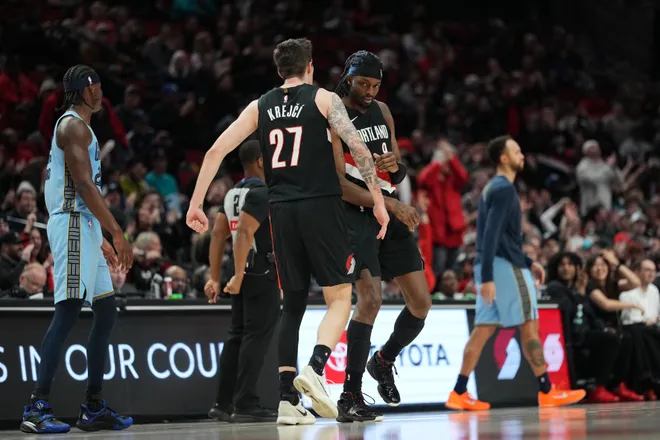 Feb 7, 2026; Portland, Oregon, USA; Portland Trail Blazers forward Jerami Grant (9) celebrates after making a three-point basket with teammate Vit Krejci (27) during the second half against the Memphis Grizzlies at Moda Center. Mandatory Credit: Soobum Im-Imagn Images