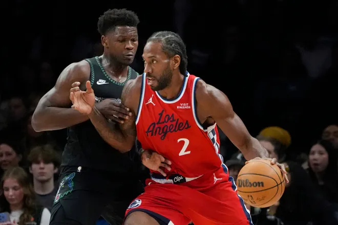 Feb 8, 2026; Minneapolis, Minnesota, USA; Los Angeles Clippers forward Kawhi Leonard (2) works around Minnesota Timberwolves guard Anthony Edwards (5) in the first quarter at Target Center. Mandatory Credit: Bruce Kluckhohn-Imagn Images
