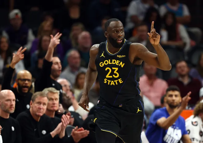 Feb 5, 2026; Phoenix, Arizona, USA; Golden State Warriors forward Draymond Green (23) reacts after a three point shot against the Phoenix Suns in the second half at Mortgage Matchup Center. Mandatory Credit: Mark J. Rebilas-Imagn Images