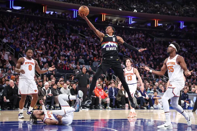 Feb 4, 2026; New York, New York, USA; Denver Nuggets guard Peyton Watson (8) drives past New York Knicks guard Jalen Brunson (11) and Ariel Hukporti (55) in the second quarter at Madison Square Garden. Mandatory Credit: Wendell Cruz-Imagn Images