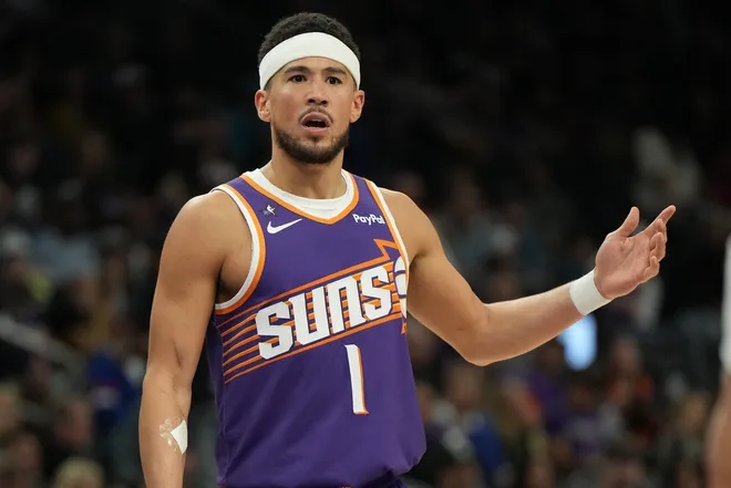 Feb 7, 2026; Phoenix, Arizona, USA; Phoenix Suns guard Devin Booker (1) reacts after a foul call against the Philadelphia 76ers during the second half of an NBA game at Mortgage Matchup Center.