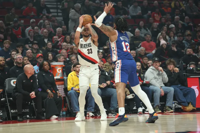 Feb 9, 2026; Portland, Oregon, USA; Portland Trail Blazers forward Toumani Camara (33) shoots the ball over Philadelphia 76ers guard/forward Trendon Watford (12) during the first half at Moda Center. Mandatory Credit: Jaime Valdez-Imagn Images