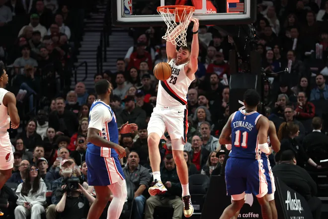 Feb 9, 2026; Portland, Oregon, USA; Portland Trail Blazers center Donovan Clingan (23) dunks the ball against the Philadelphia 76ers during the second half at Moda Center. Mandatory Credit: Jaime Valdez-Imagn Images