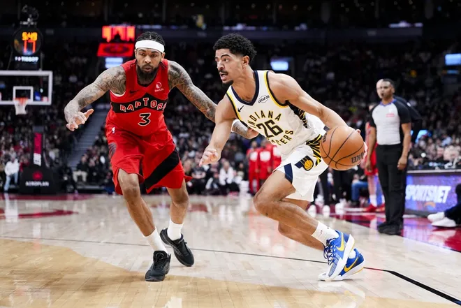 Feb 8, 2026; Toronto, Ontario, CAN; Indiana Pacers guard Ben Sheppard (26) dribbles against Toronto Raptors forward Brandon Ingram (3) during the second half at Scotiabank Arena.