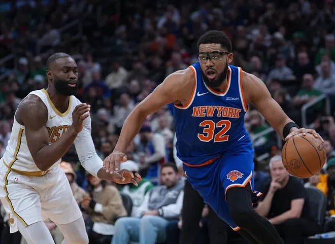 Feb 8, 2026; Boston, Massachusetts, USA; New York Knicks center Karl-Anthony Towns (32) drives the ball against Boston Celtics guard Jaylen Brown (7) in the second quarter at TD Garden.