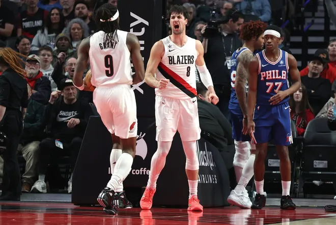 Feb 9, 2026; Portland, Oregon, USA; Portland Trail Blazers forward Deni Avdija (8) reacts towards teammate forward Jerami Grant (9) after scoring as Philadelphia 76ers guard Vj Edgecombe (77) watches during the second half at Moda Center.