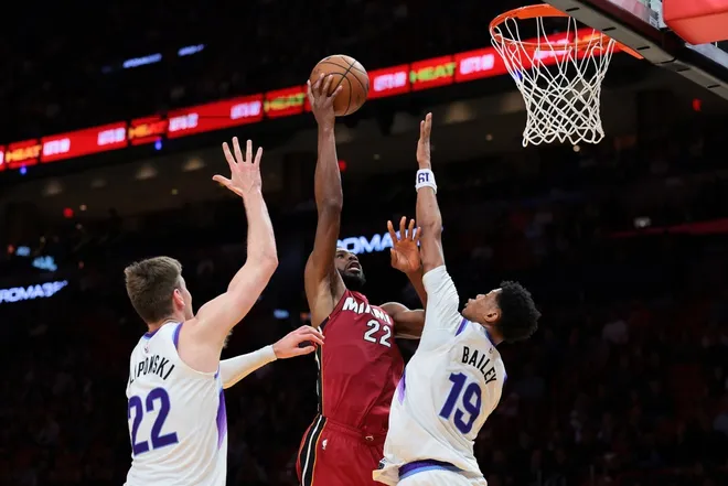 Feb 9, 2026; Miami, Florida, USA; Miami Heat forward Andrew Wiggins (22) drives to the basket against Utah Jazz forward Kyle Filipowski (22) and guard Ace Bailey (19) during the fourth quarter at Kaseya Center.
