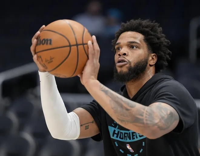 Feb 9, 2026; Charlotte, North Carolina, USA; Charlotte Hornets forward Miles Bridges (0) shoots during pregame warm ups against the Detroit Pistons at Spectrum Center.